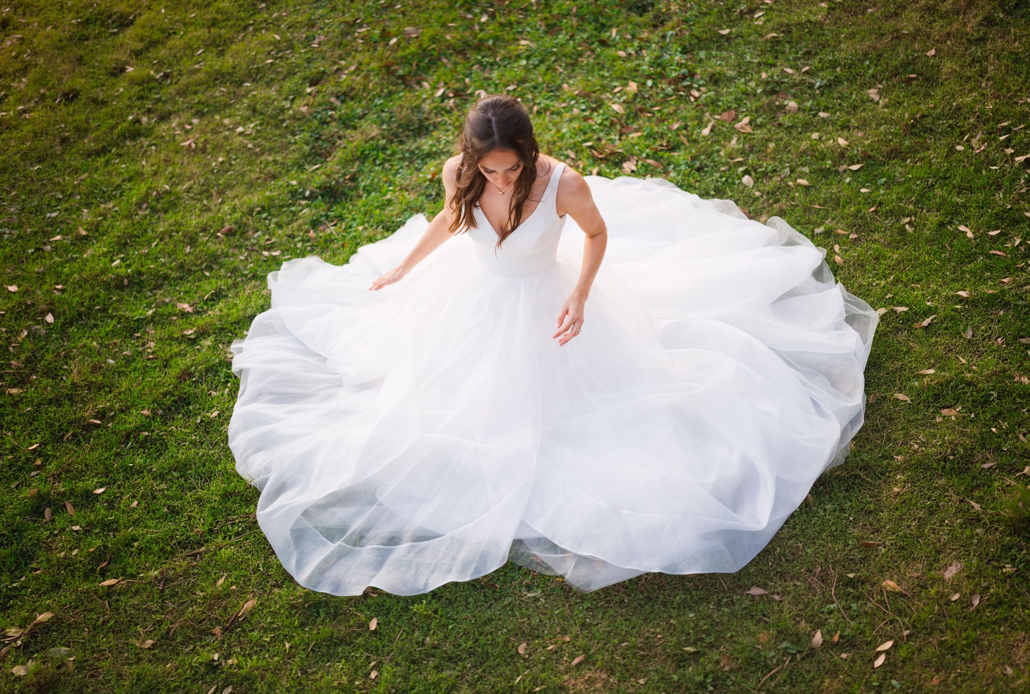Overhead bridal gown tulle circle green lawn