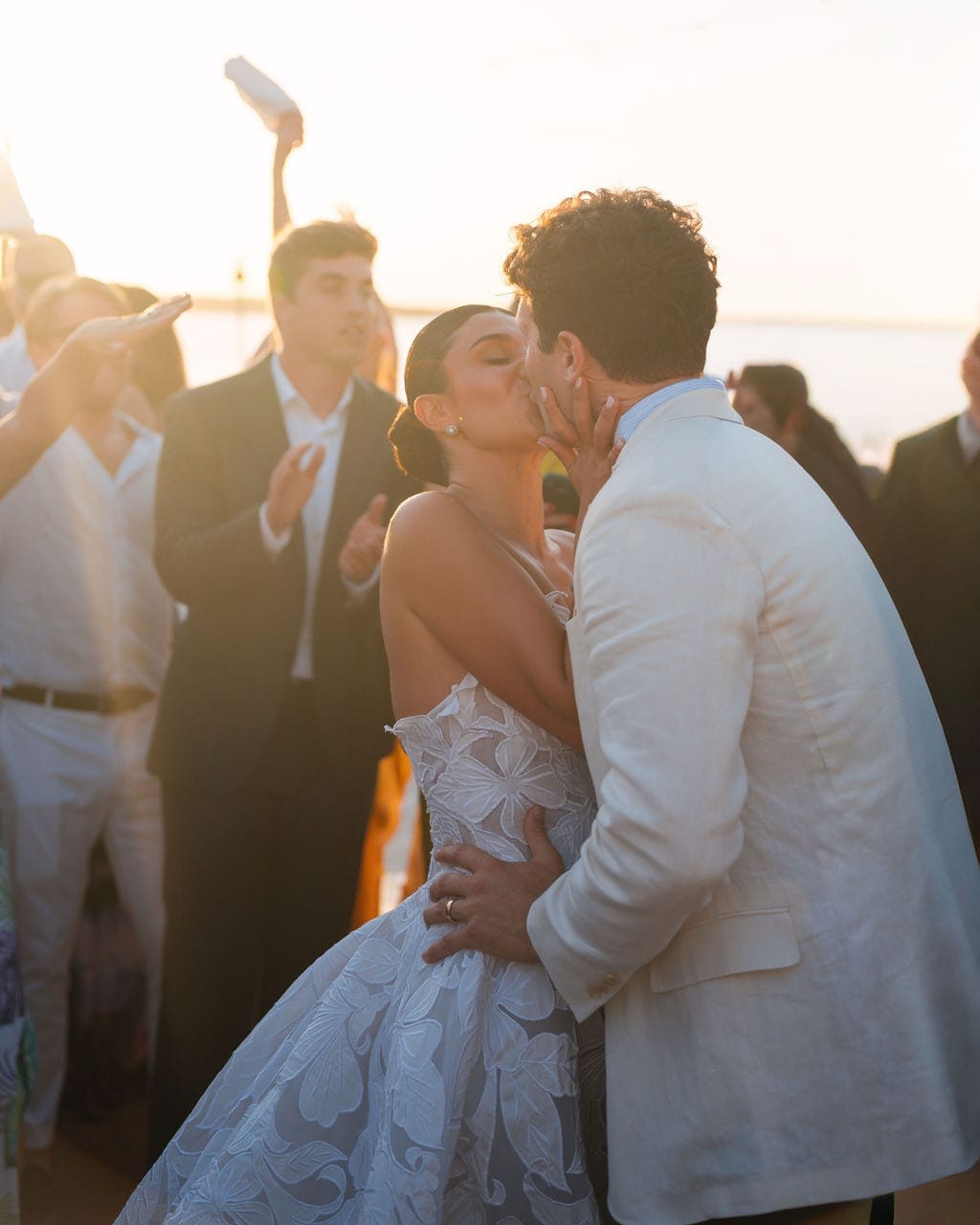 Bride and groom kissing during dance golden hour waterfront