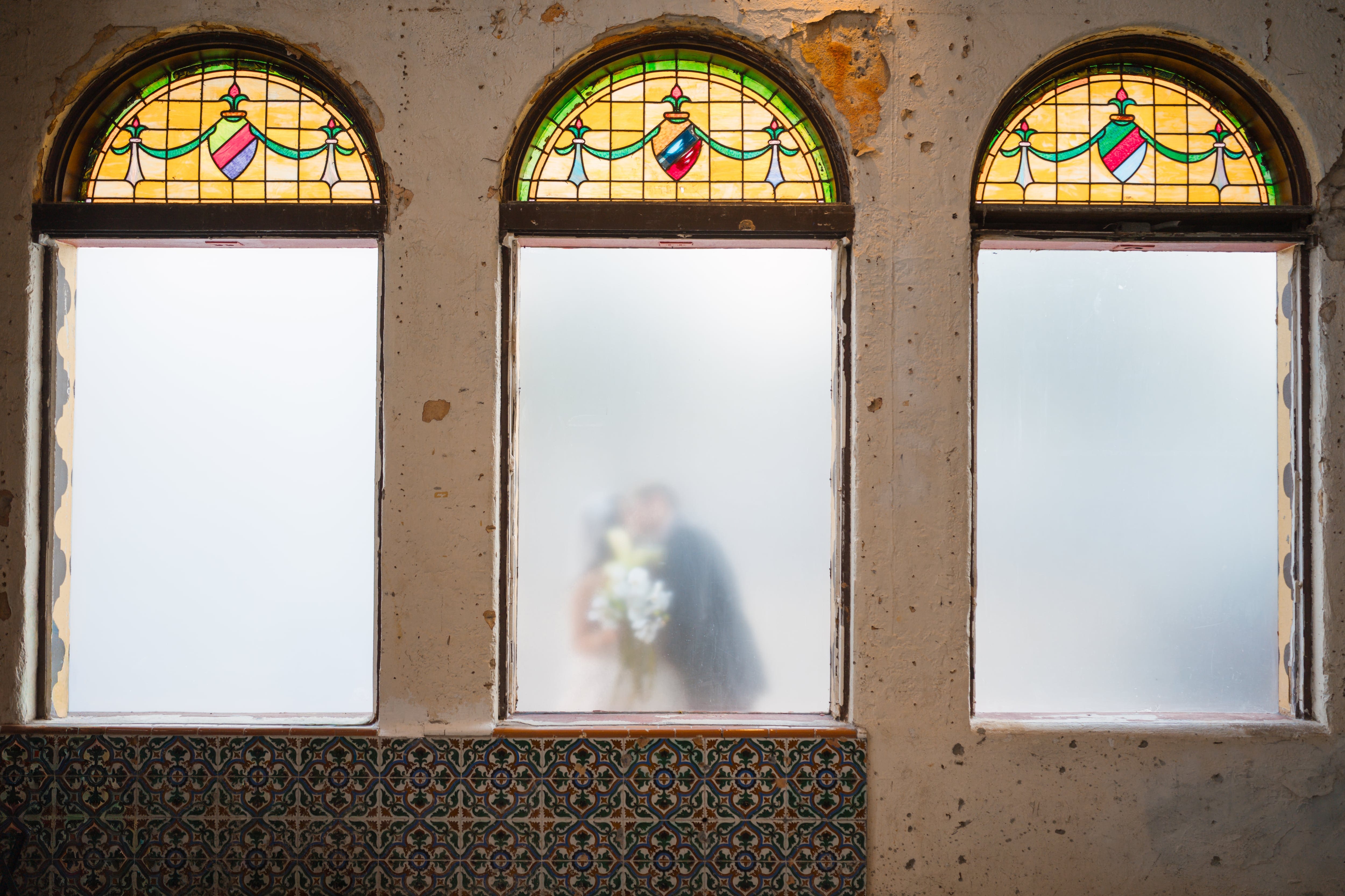 Bride groom kiss frosted glass stained glass tampa wedding