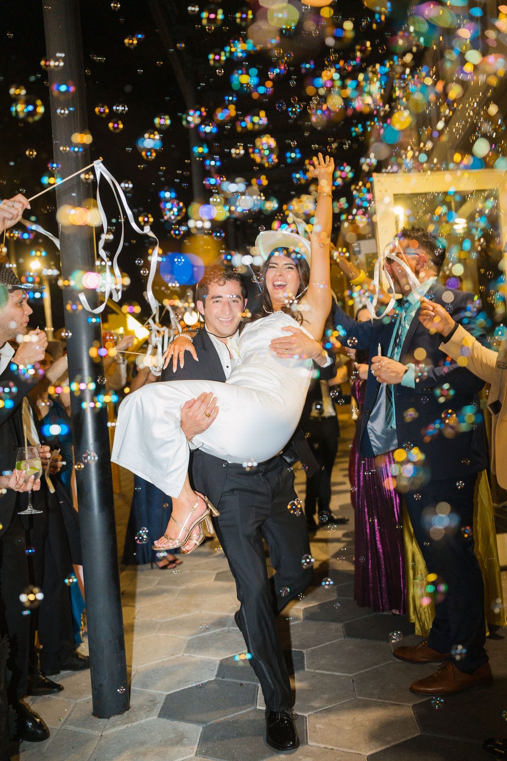 Bubble exit groom carrying bride
