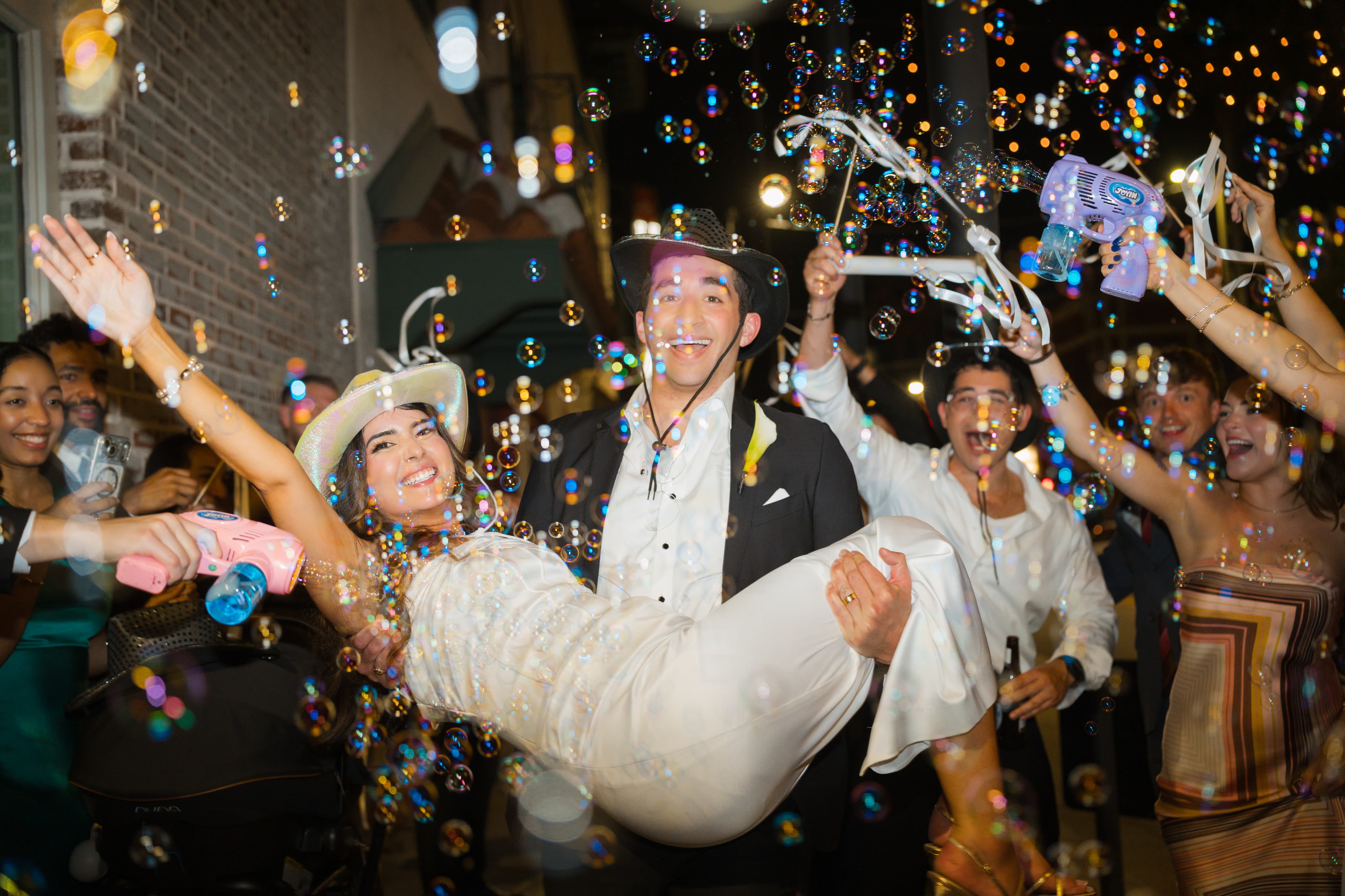 Newlyweds bubble exit cowboy hats hotel haya