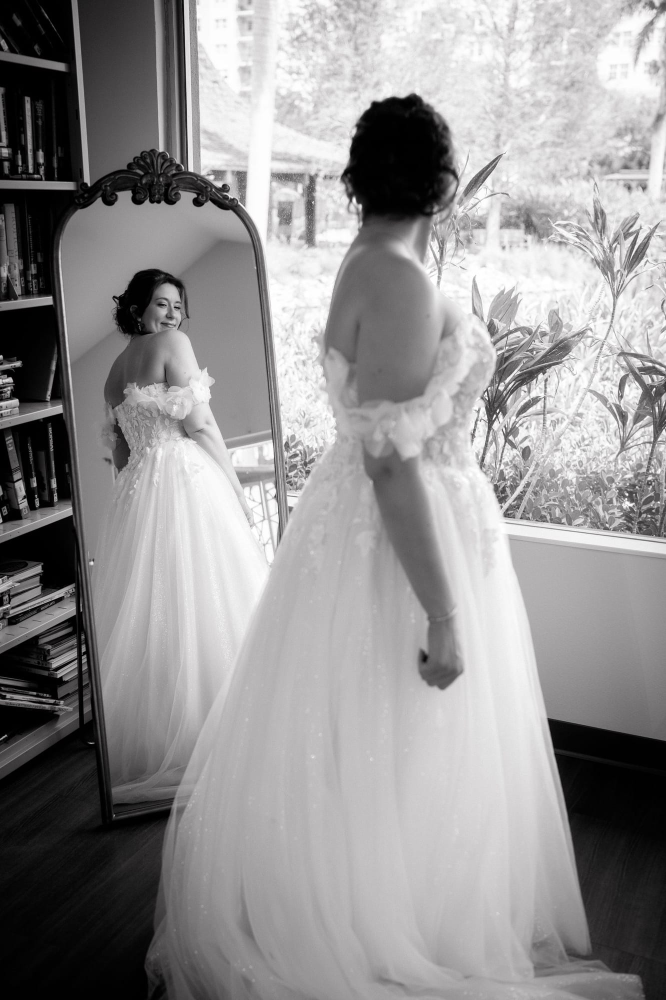 Bride getting ready in front of a mirror before a summer wedding