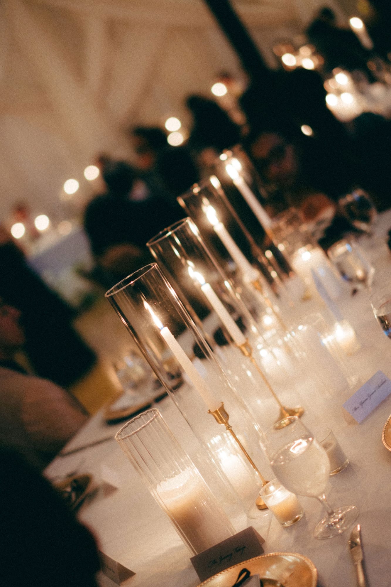 Taper candles in varying heights on a wedding reception table