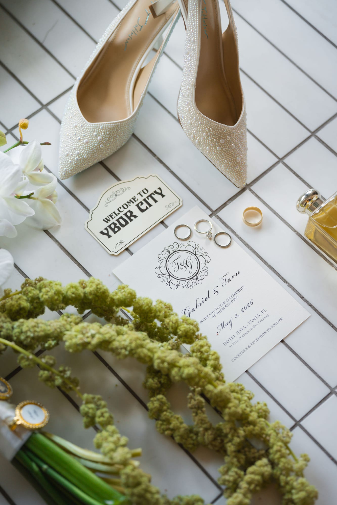 Wedding detail flat lay with shoes, invitation suite, rings and greenery from a Tampa wedding