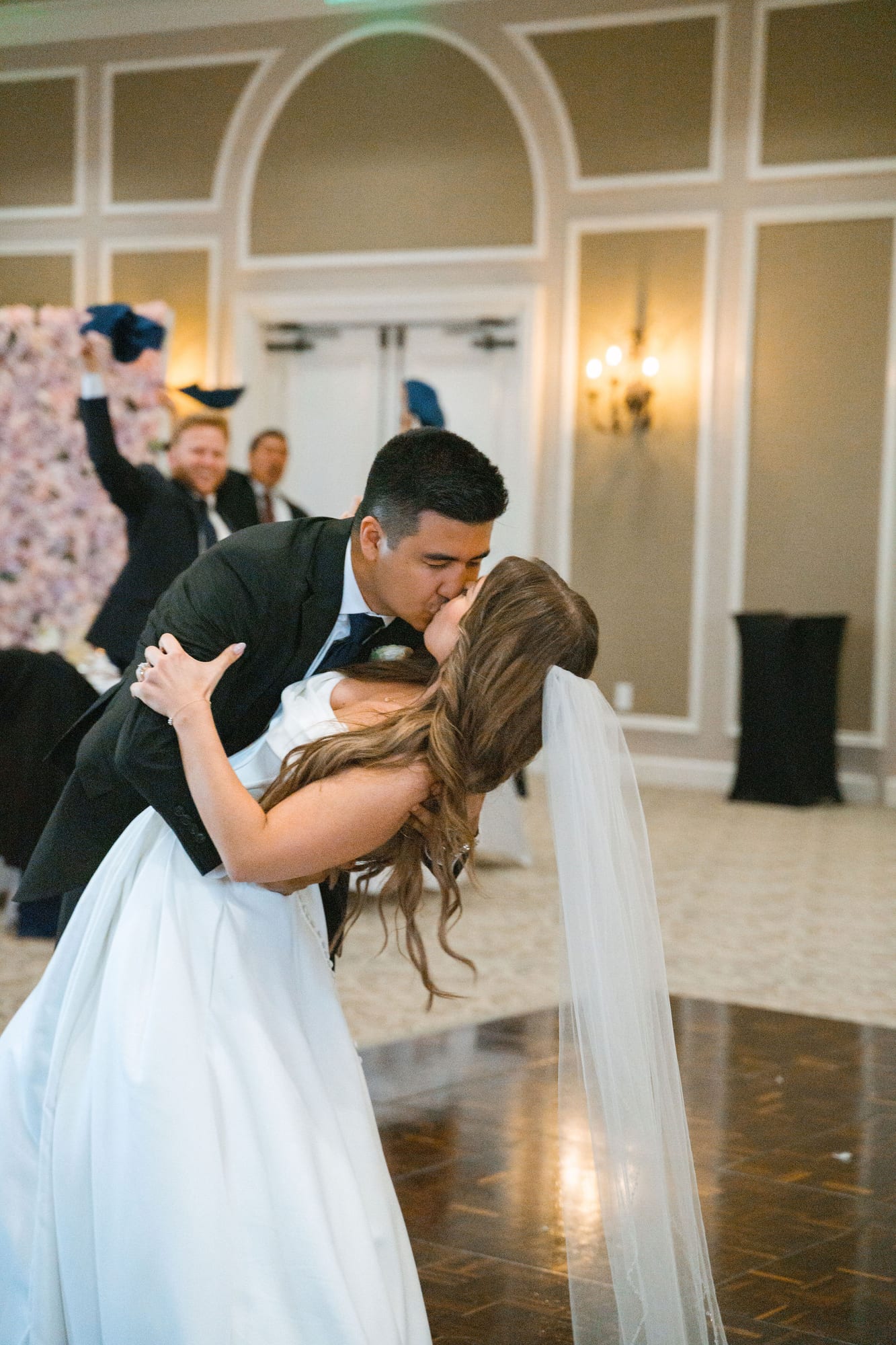 Groom dipping his bride for a kiss on the ballroom dance floor at Lakewood Ranch Golf and Country Club