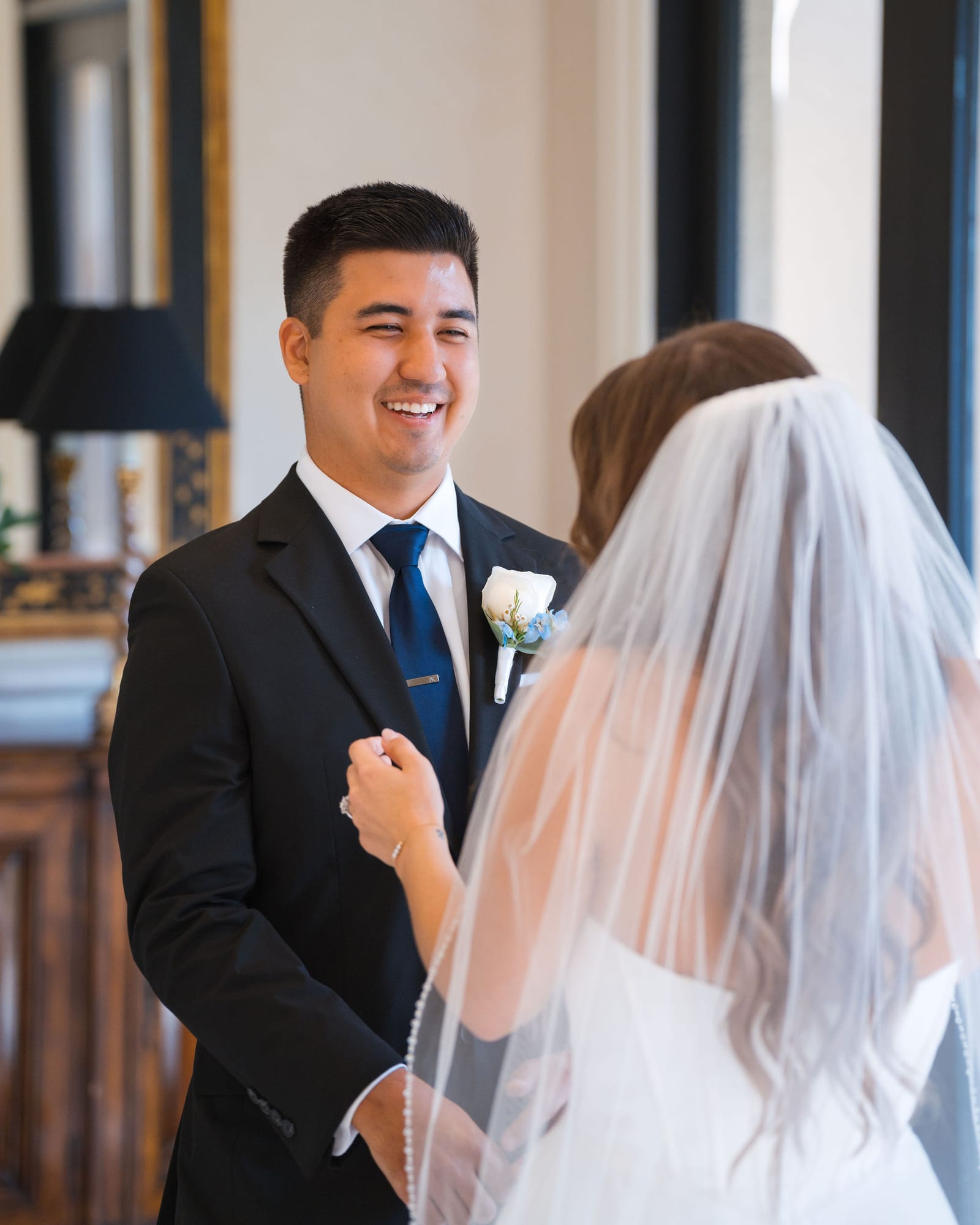 Groom Jacob smiling big as he sees his bride for the first time
