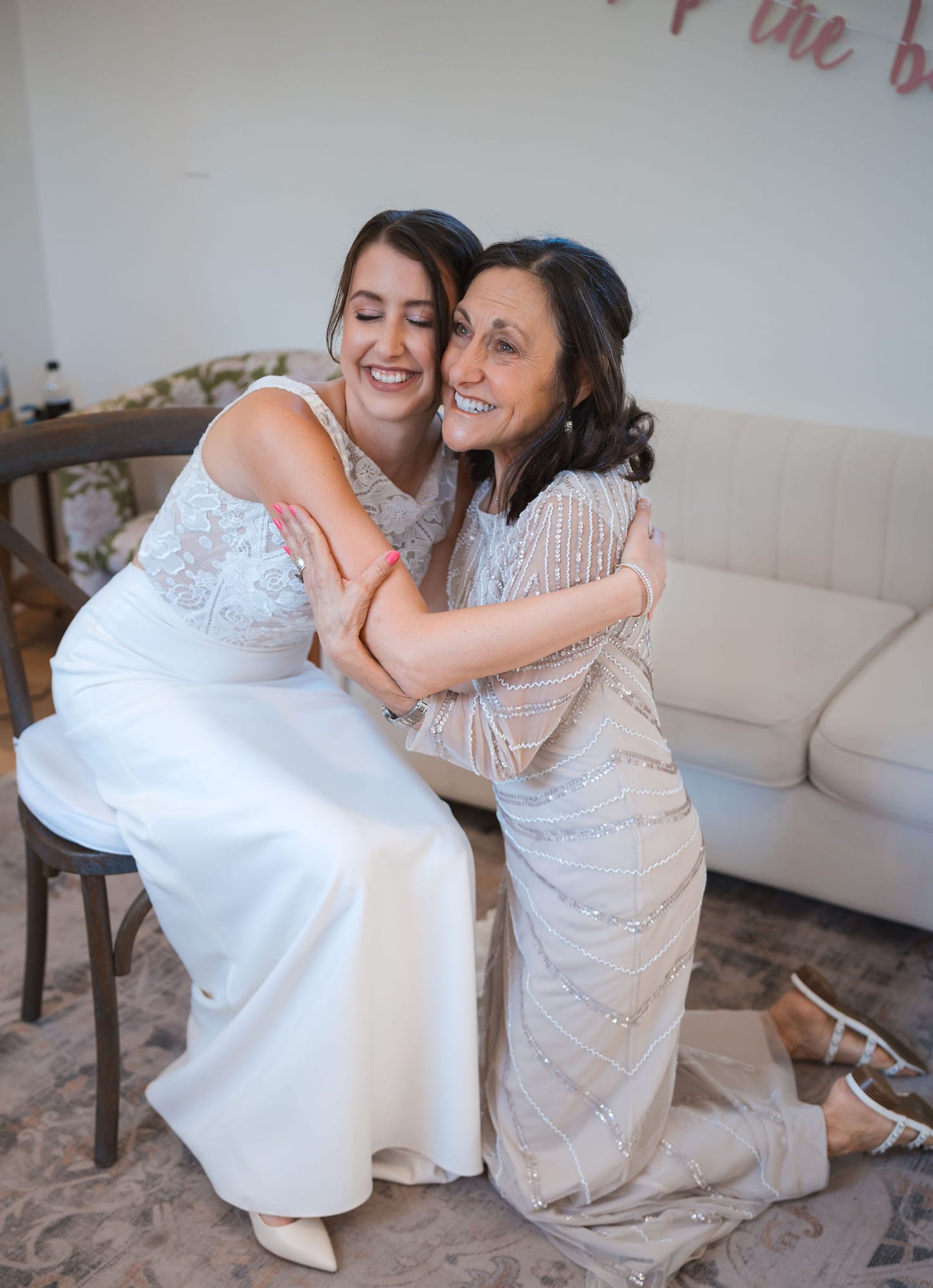 Bride hugging her mother in the bridal suite before the ceremony