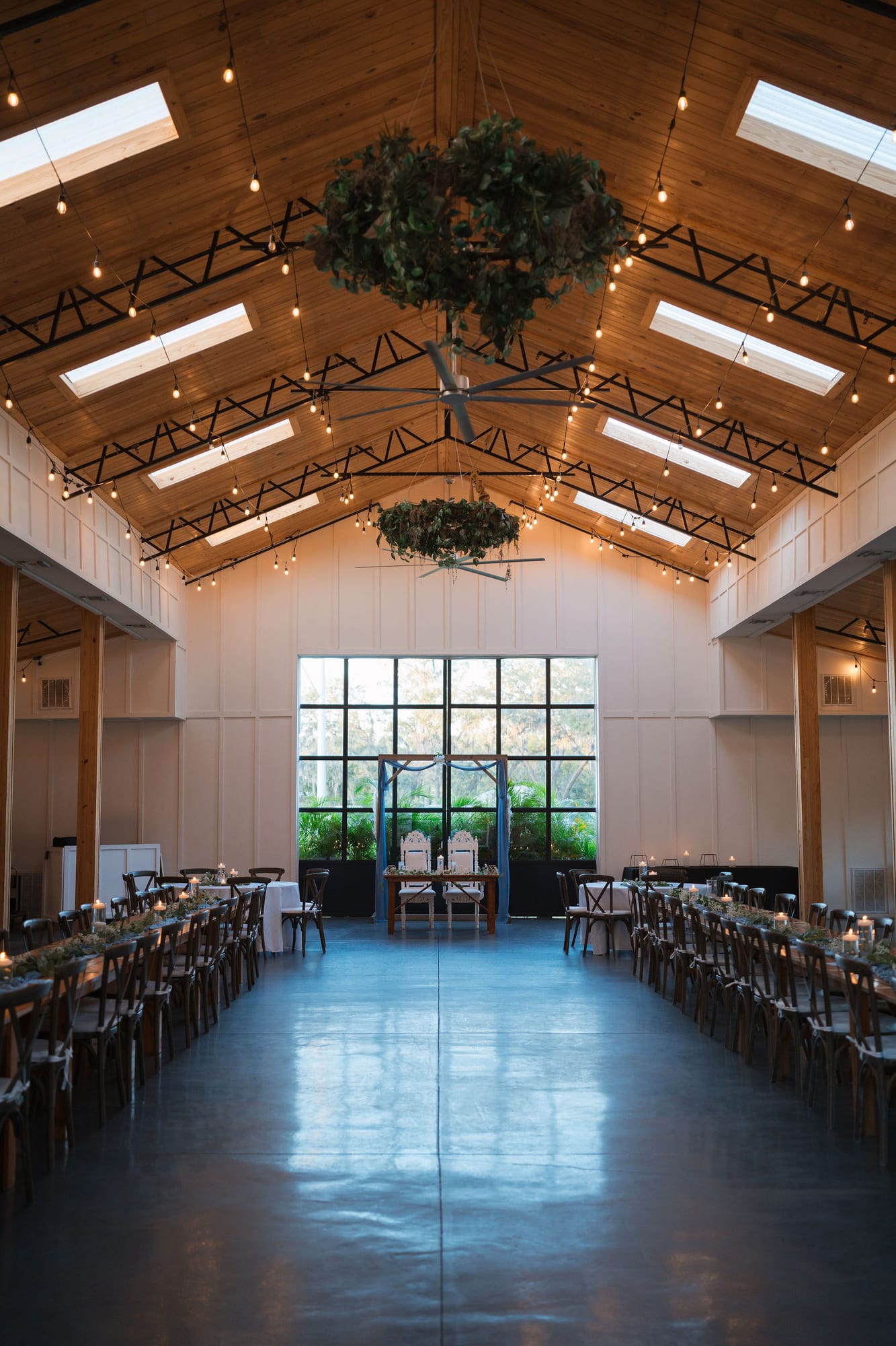 The Pavilion reception space at SoireEstate with wooden ceilings and greenery chandeliers