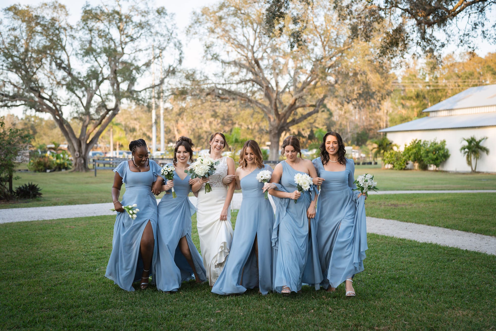 Wedding party walking the lawn at The Overlook framed by live oaks at SoireEstate