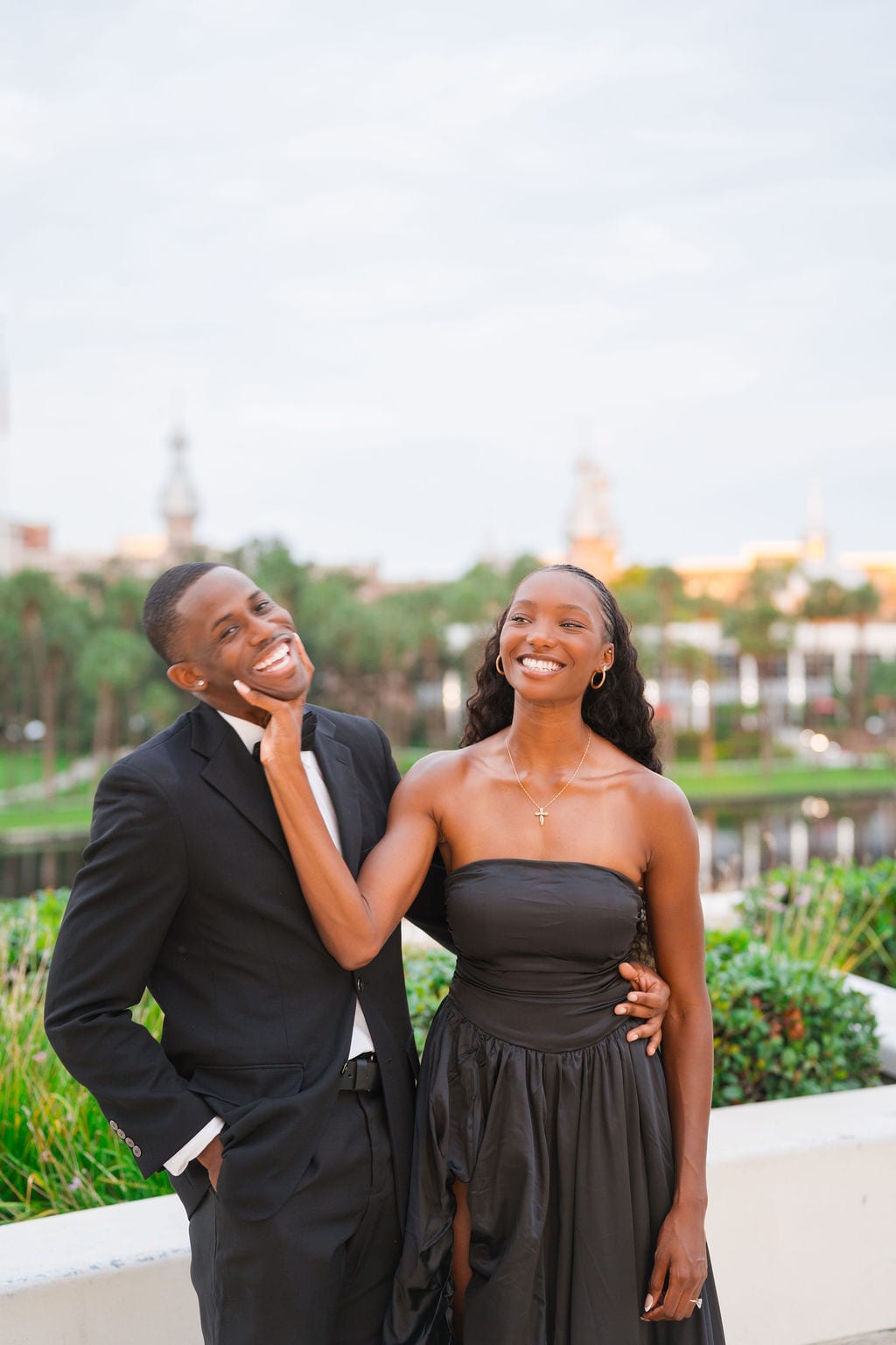 Engaged couple laughing in front of the University of Tampa minarets during an engagement session in Tampa