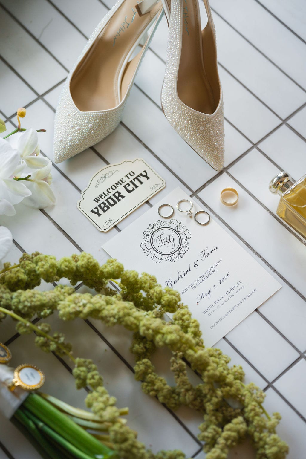 Wedding detail flat lay with rings, shoes and invitation from an Ybor City wedding in Tampa